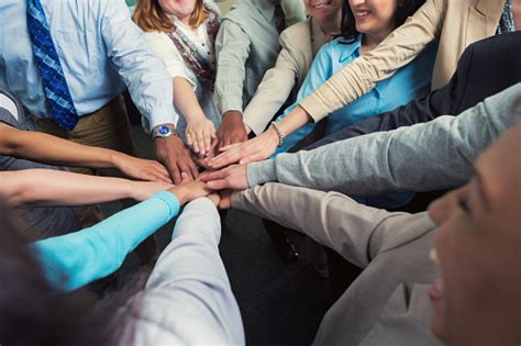 Diverse Team Of Businesspeople With Hands In Teamwork Huddle Stock