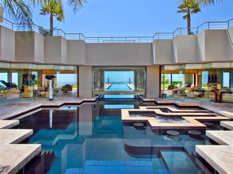 An Indoor Swimming Pool Surrounded By Palm Trees