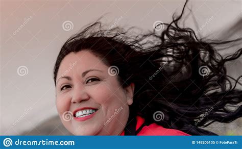 Beautiful Latin Mexican Woman With Long Black Hair Tousled By The Wind