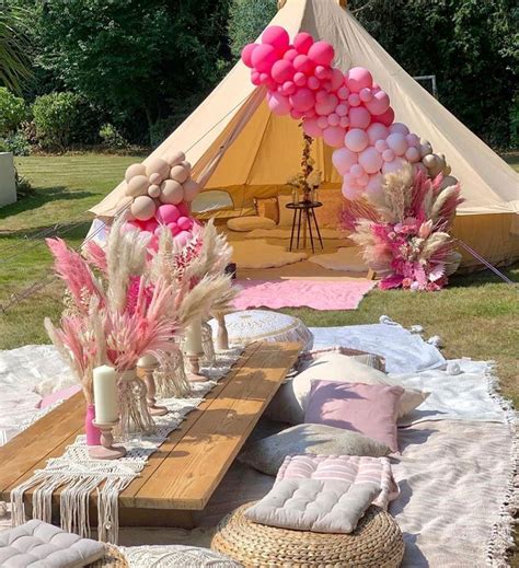 A Tent Set Up For A Party With Pink And White Balloons On The Ceiling