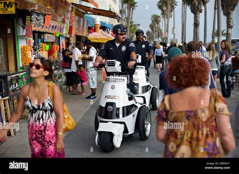 Police Officers Patrol The Venice Boardwalk On Customized Segway Scooters In Los Angeles Stock