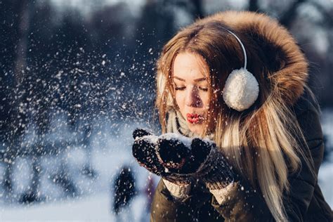 Woman Blowing Snow From Hand · Free Stock Photo