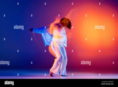Image Of Flexible Young Girl Hip Hop Dancer In White Outfit Dancing Hip Hop Isolated On Blue