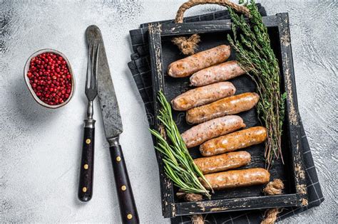 Roasted Bratwurst Hot Dog Sausages In A Wooden Tray With Herbs White