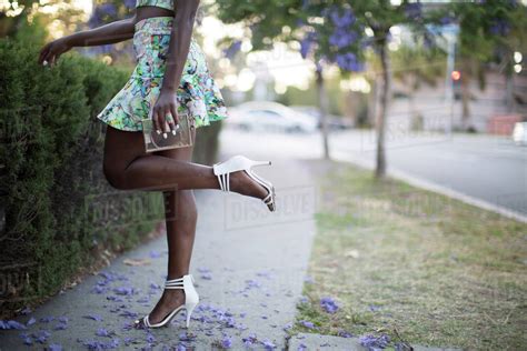 Woman Wearing Heels On Neighborhood Sidewalk Stock Photo Dissolve