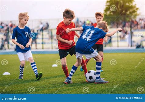 Kids Kicking Football Ball Boys Play Soccer On Grass Field Stock Image