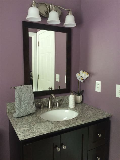 Most of the vanity is located or mounted at the corner of the room. Bathroom remodel- plum paint, granite, dark vanity (With ...