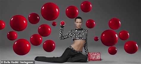 bella hadid goes topless behind massive lv bag for brand campaign collab with yayoi kusama