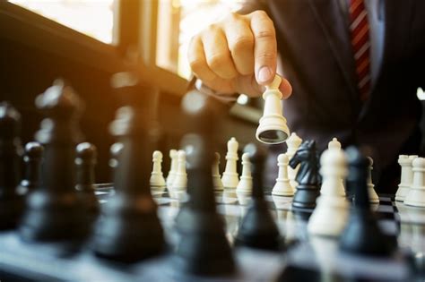 Premium Photo Businessman Playing Chess On Board In Office Strategy