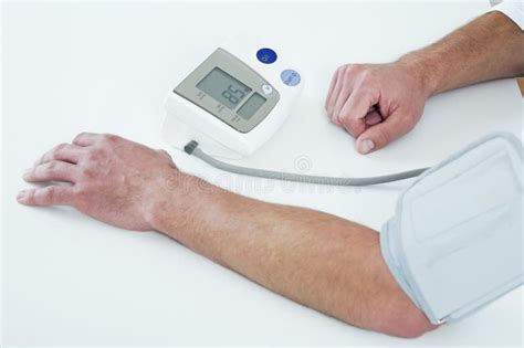 Man Having A Blood Pressure Examination Conceptual Image Stock Photo