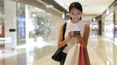 Shopping Woman Using Smart Phone At Shopping Center Nepa