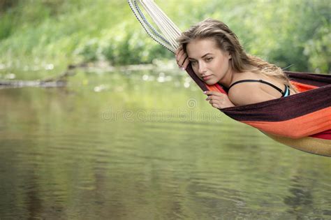 Girl In A Bathing Suit Lying In A Hammock Over The Water Stock Image