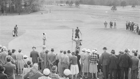 patrons watch as henry picard putts on the 18th green during the 1938 masters tournament at