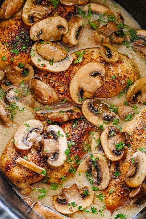 A Pan Filled With Chicken Mushrooms And Parsley
