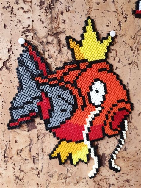 A Red Bird With A Crown On It S Head Is Made Out Of Perler Beads