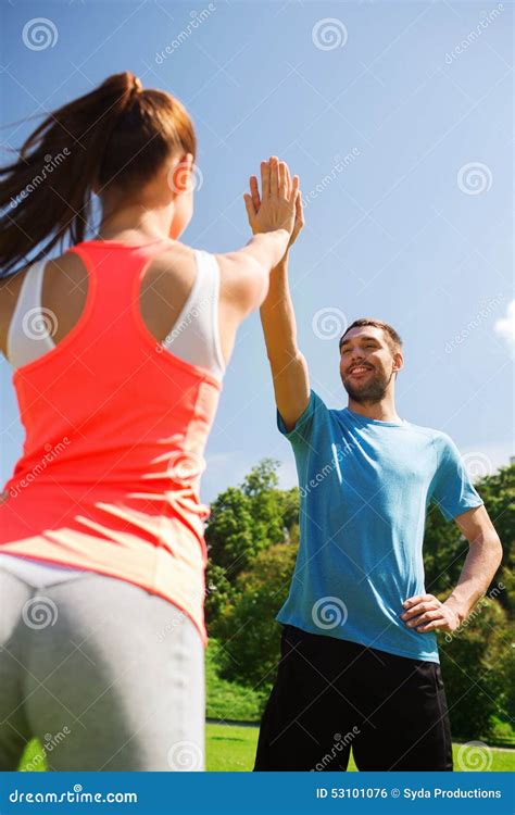 Two Smiling People Making High Five Outdoors Stock Photo Image Of