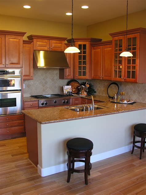 Others draw design inspiration from bygone movie and tv favorites. About | Staggered kitchen cabinets, Brown kitchens ...