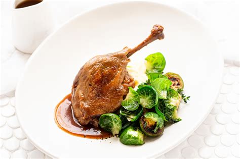 Confit Duck Legs With Garlic Mash Brussel Sprouts Angelakis Bros