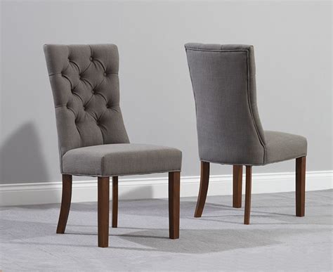 The upholstered dining chair's slim, warm grey hardwood legs taper gracefully to the floor. Anais Grey Fabric Dark Oak Leg Dining Chairs | Fantastic ...
