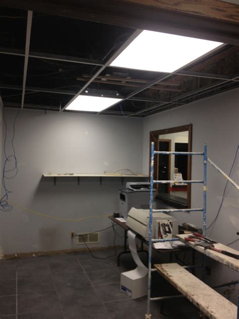 Ceiling mounted wall paper is the worst. Removing ceiling tiles at Midstate Truck - Complete Service