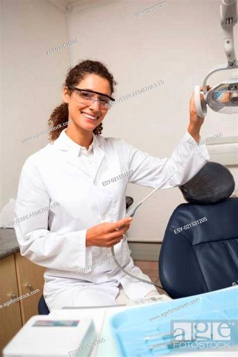 Dentist Holding Drill Smiling At Camera Stock Photo Picture And Low