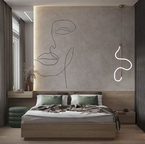 A Bedroom With A Large Bed And Artwork On The Wall Next To Its Headboard