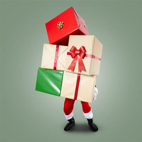 Santa Claus Carrying A Big Pile Of Christmas Presents Stock Image