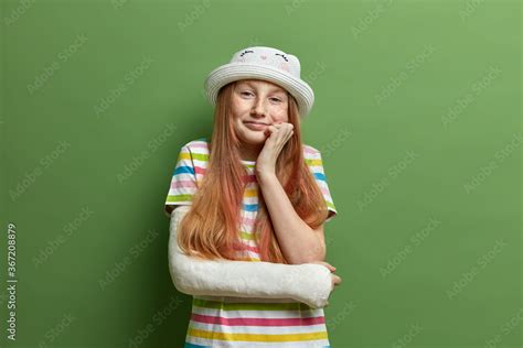 Pleased Adorable Preteen Girl Keeps Hand Under Chin Has Smiling