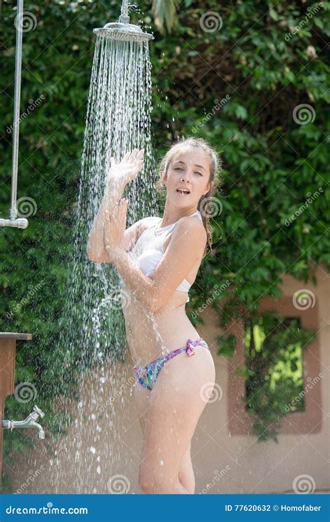Girl Wear Bikini Standing Under The Outdoor Pool Shower Stock Photo