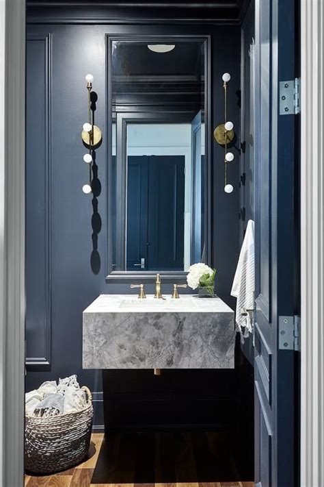 You can decorate your powder room in every single style, but it need to fit with the bathroom decor. Stunning black paneled powder room is fitted with a tall ...