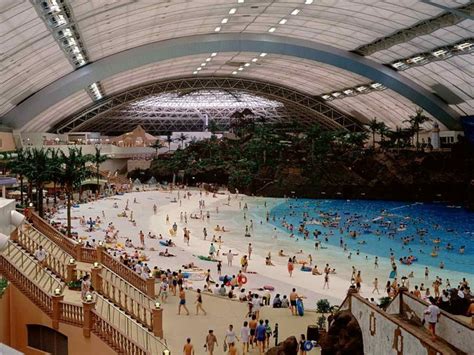 An Indoor Swimming Pool With Many People In It