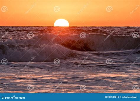 The Sun Sets Into The Pacific Ocean From A Beach On The West Coast