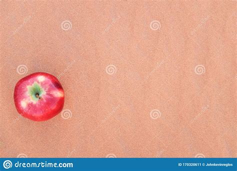 A Red Apple Isolated On A Dry Desert Sand Food Security