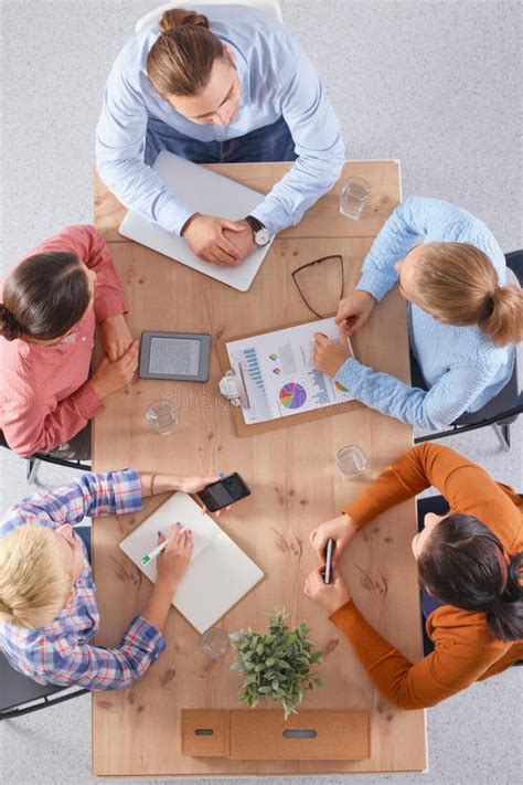 Business People Sitting And Discussing At Meeting In Office Stock