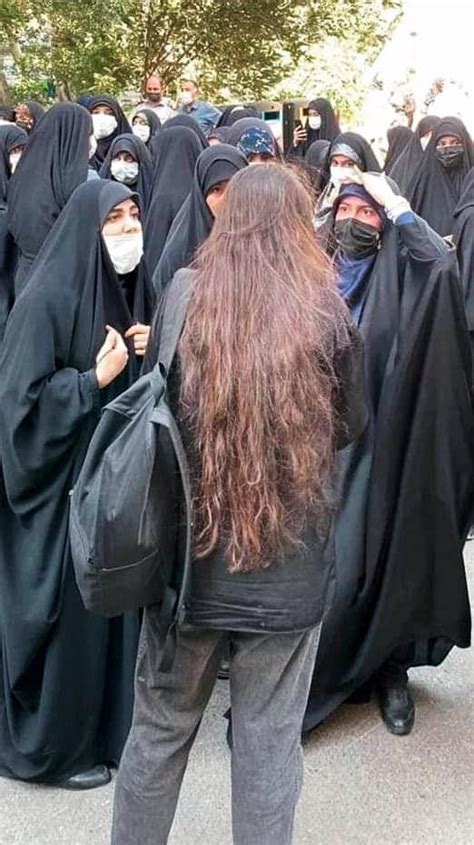 iranian woman with her hair exposed in front of the pro islamic republic counter protest pics