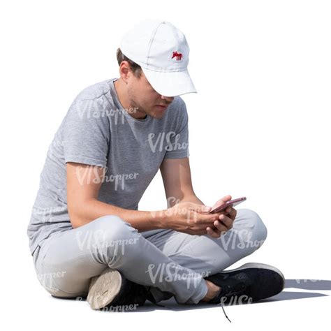 Young Man Sitting On The Ground And Texting Vishopper