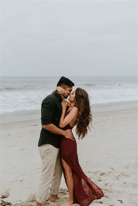 A Man And Woman Kissing On The Beach