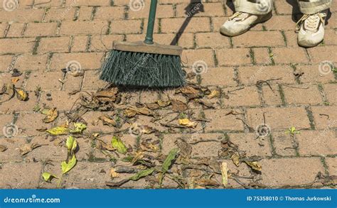 Sweeping Leaves A Broom Stock Photo Image Of Bricks 75358010