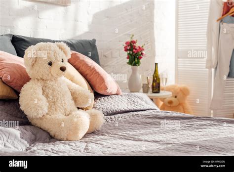 Selective Focus Of Teddy Bear Toy On Bed In Modern Bedroom With Copy