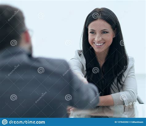 Handshake Young Business Woman With A Partner In The Office Stock Photo