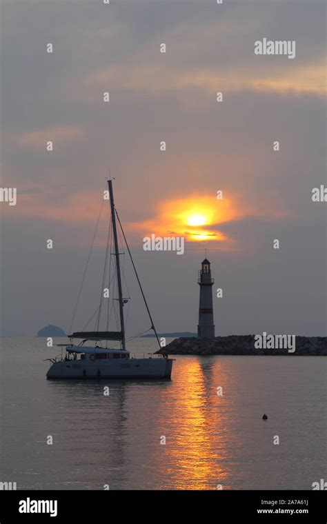 Seascape At Sunset Lighthouse On The Coast Seaside Town Of Turgutreis