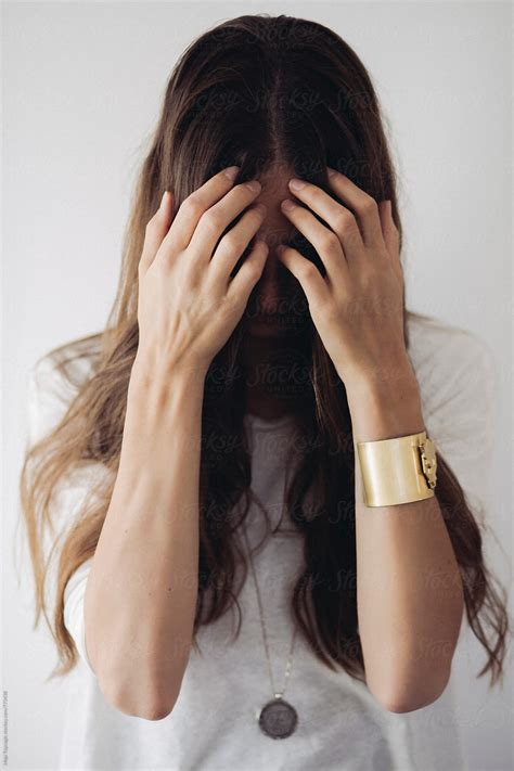 Young Beautiful Woman With Long Brown Hair Covering Her Face With