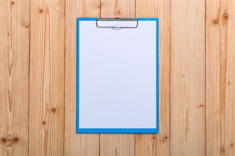 Premium Photo Clipboard With Blank White Paper Sheet On Wood Table