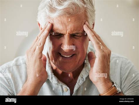 Senior Man Suffering With Headache Pain From Stress And Painful Head