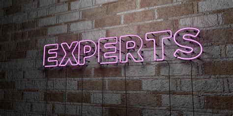 Experts Glowing Neon Sign On Stonework Wall 3d