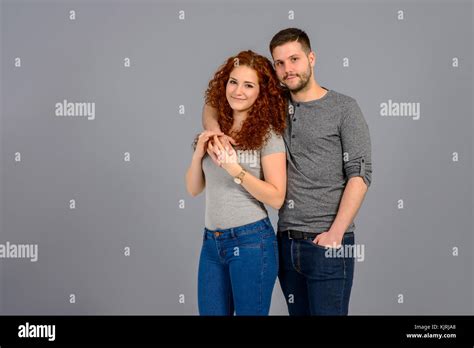 A Young Man Resting His Arms On The Shoulder Of His Beautiful Girlfriend And Holding Her Hand