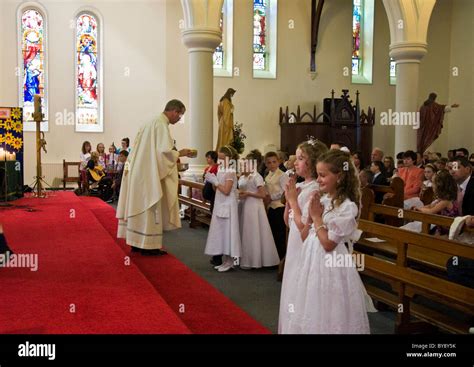 Children In A Roman Catholic Church Take Their First Communion Stock