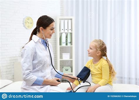Little Girl Visiting Doctor Measuring Blood Pressure And Checking