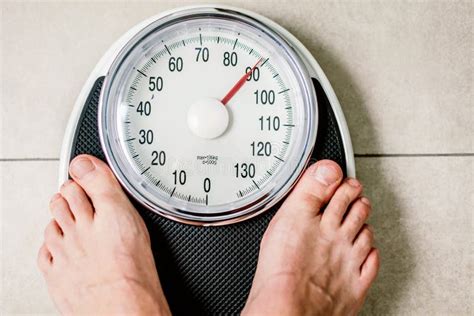 Close Up Weighing Scale Men Standing On Weigh Scales Stock Photo