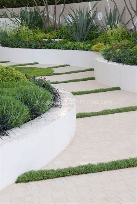 Gone are the voluminous shapes and profusion of colours. rendered retaining wall ideas #retainingwallideas | Garden paths, Garden design, Mediterranean ...